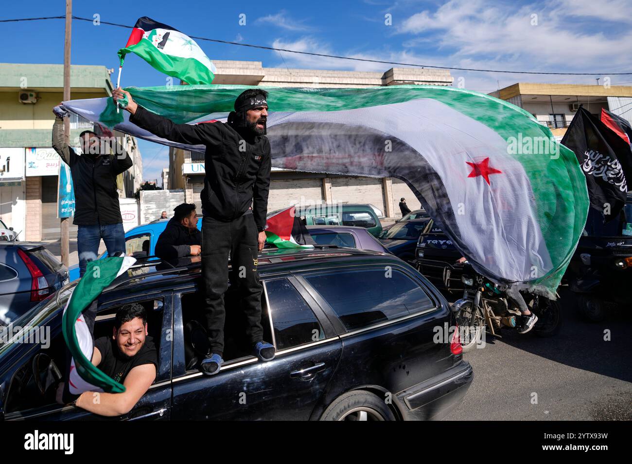 Syrians celebrate the fall of Syrian President Bashar Assad's government in the town of Bar Elias, Lebanon, near the border with Syria, Sunday, Dec. 8, 2024. (AP Photo/Hassan Ammar) Stock Photo