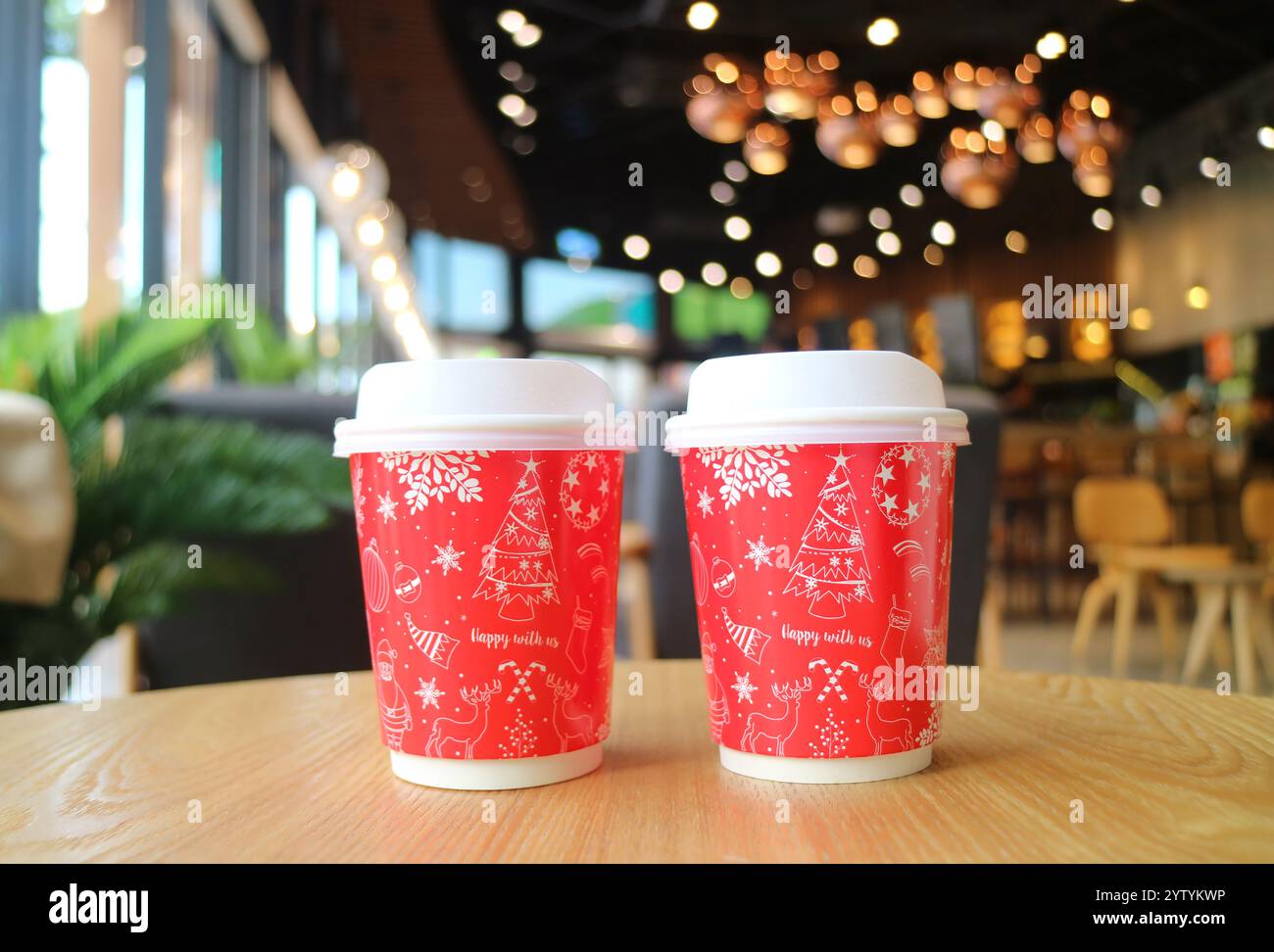 Pair of Red and White Takeaway Christmas Coffee Cup on the Table Stock Photo