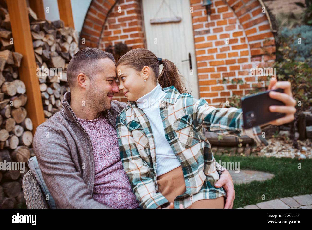 Father touching forehead with daughter, taking selfie Stock Photo - Alamy