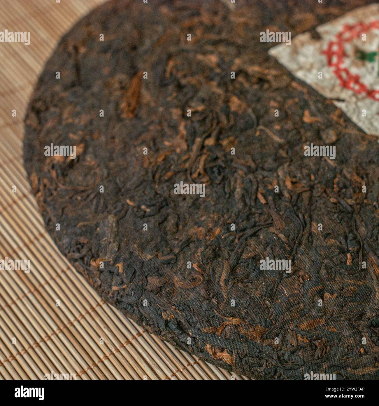 Here Is A Detailed View Showcasing A Traditional Puerh Tea Cake here-is-a-detailed-view-showcasing-a-traditional-puerh-tea-cake