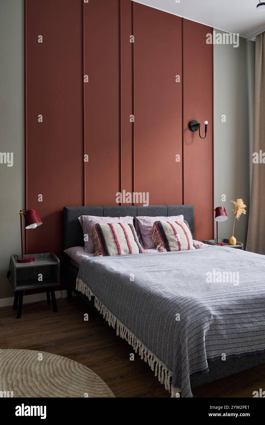 View of This modern bedroom features a stylish accent wall paired with cozy ...