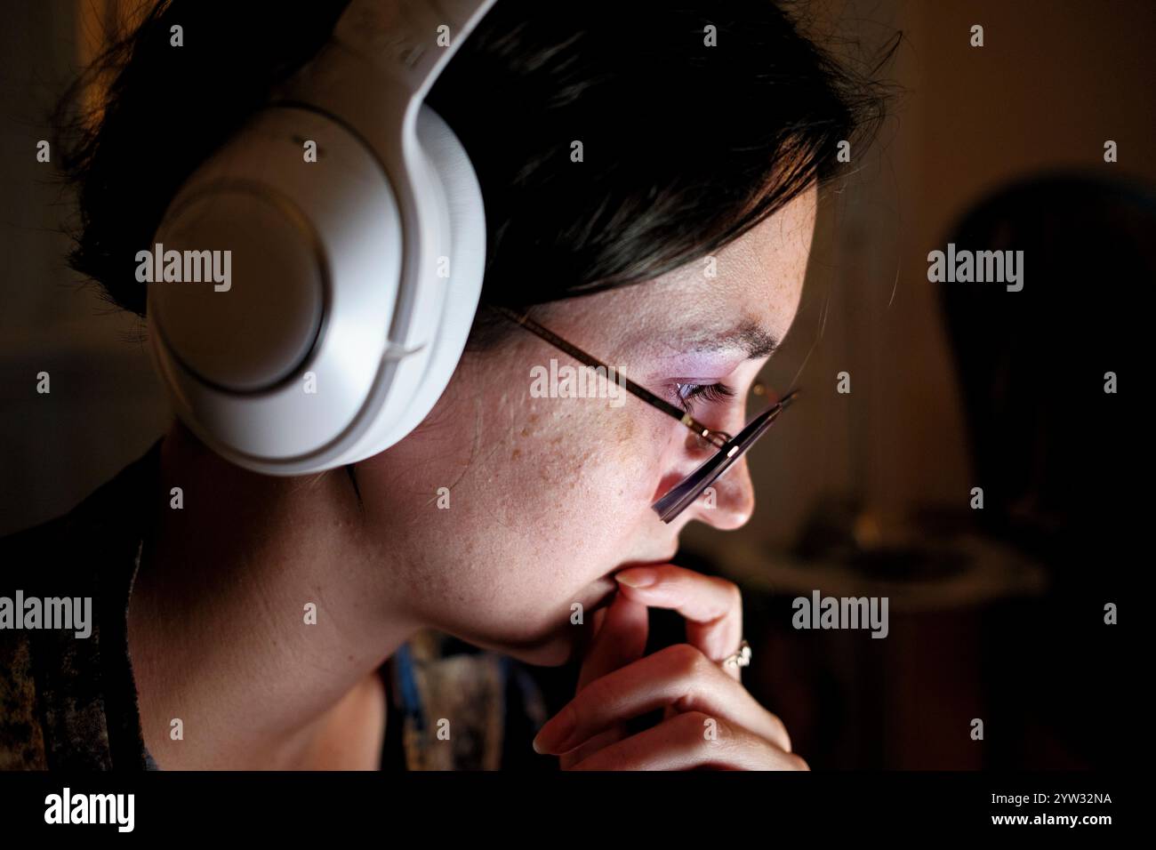 Side profile of a woman wearing headphones hi-res stock