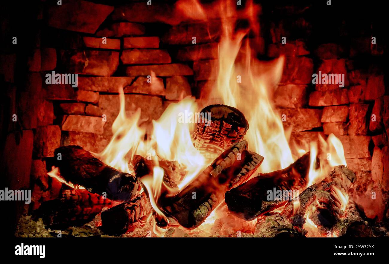 Flame Display on TV providing psychological winter warmth and avoiding costly home heating bills. England UK Stock Photo