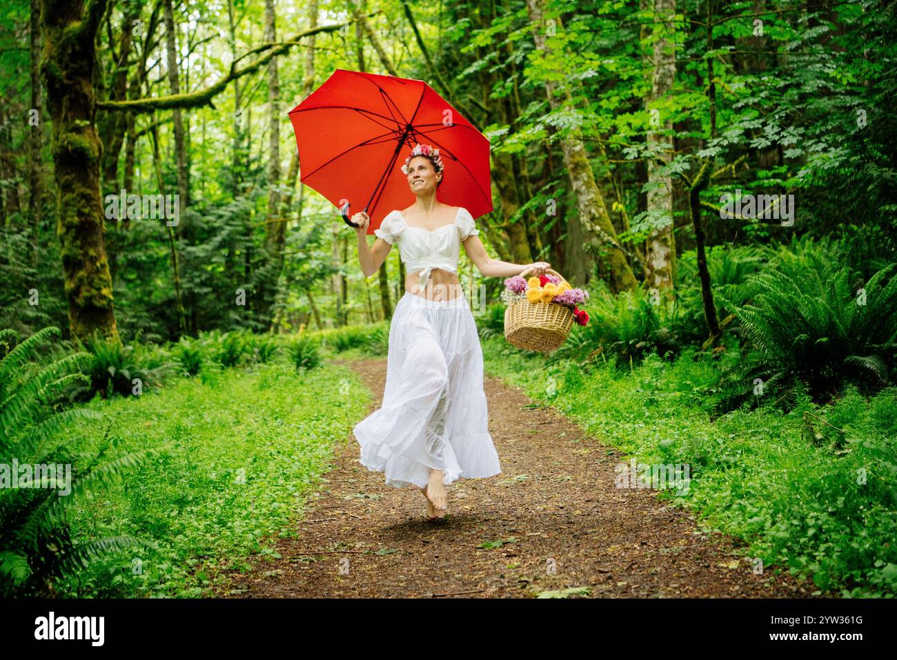 Woman walks through serene forest hi-res stock photography and images ...