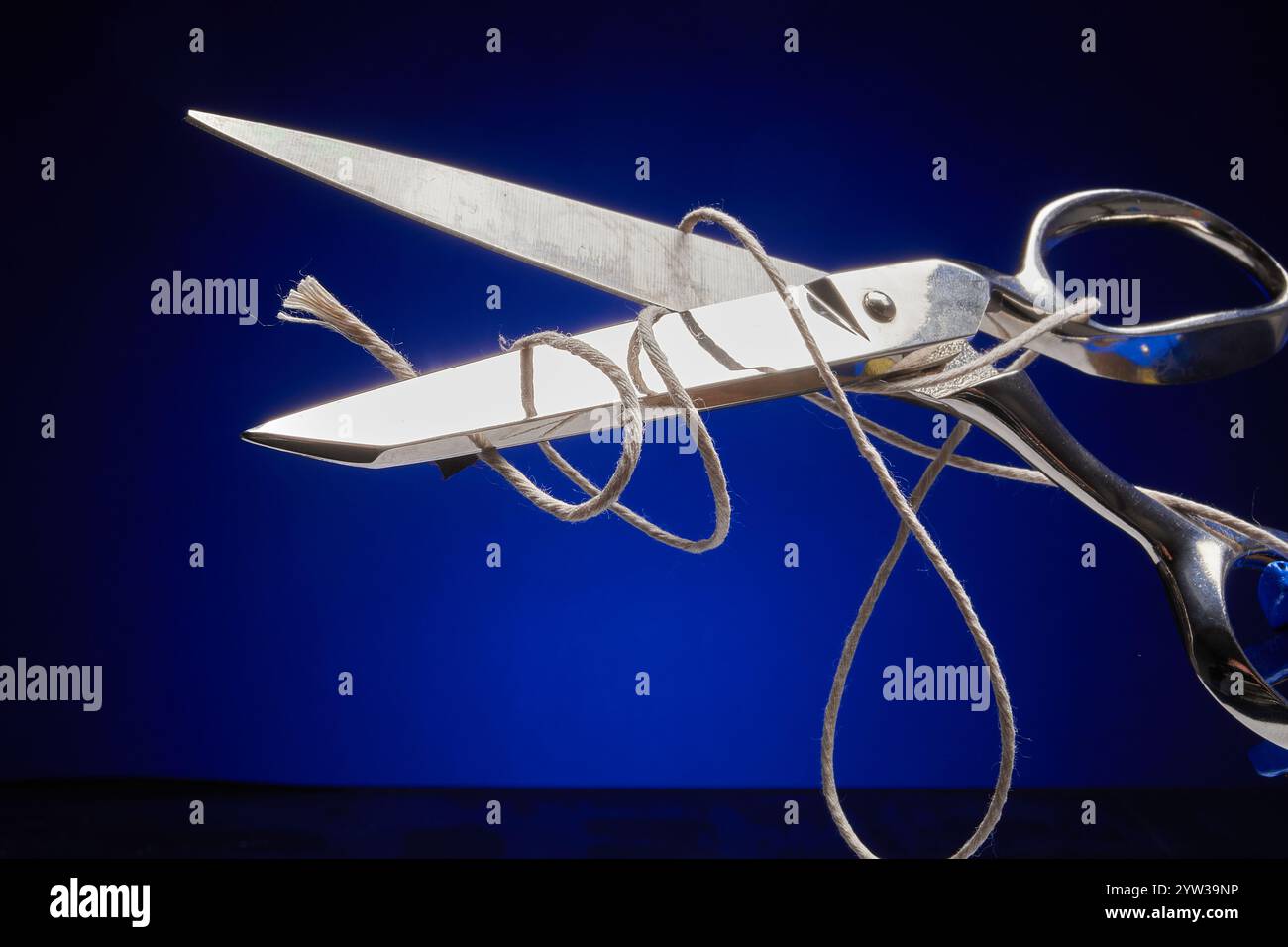 Scissors cutting twine into pieces Stock Photo - Alamy