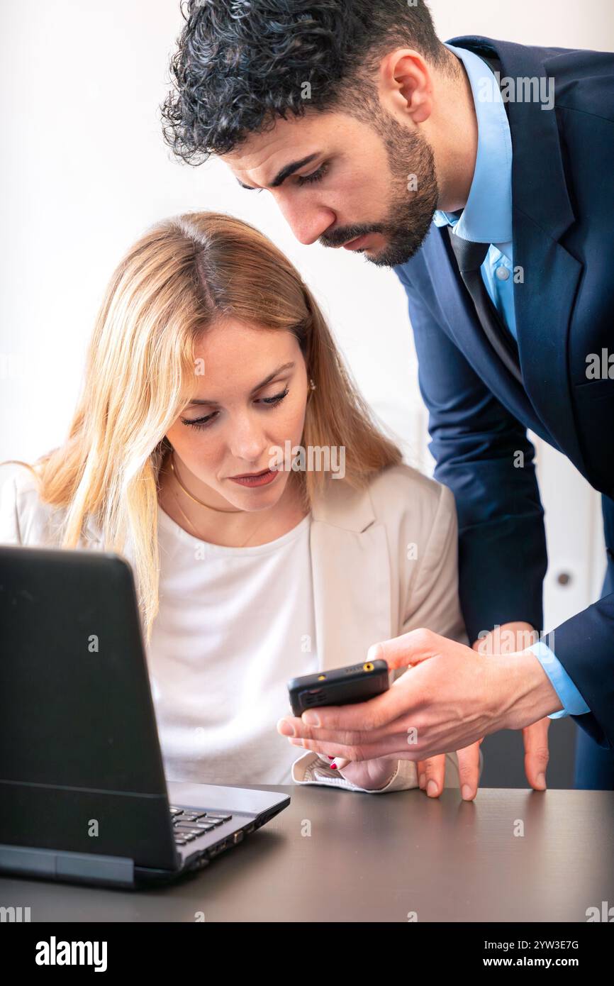 Business Colleagues Collaborating with Smartphone in Modern Office.Vertical Stock Photo