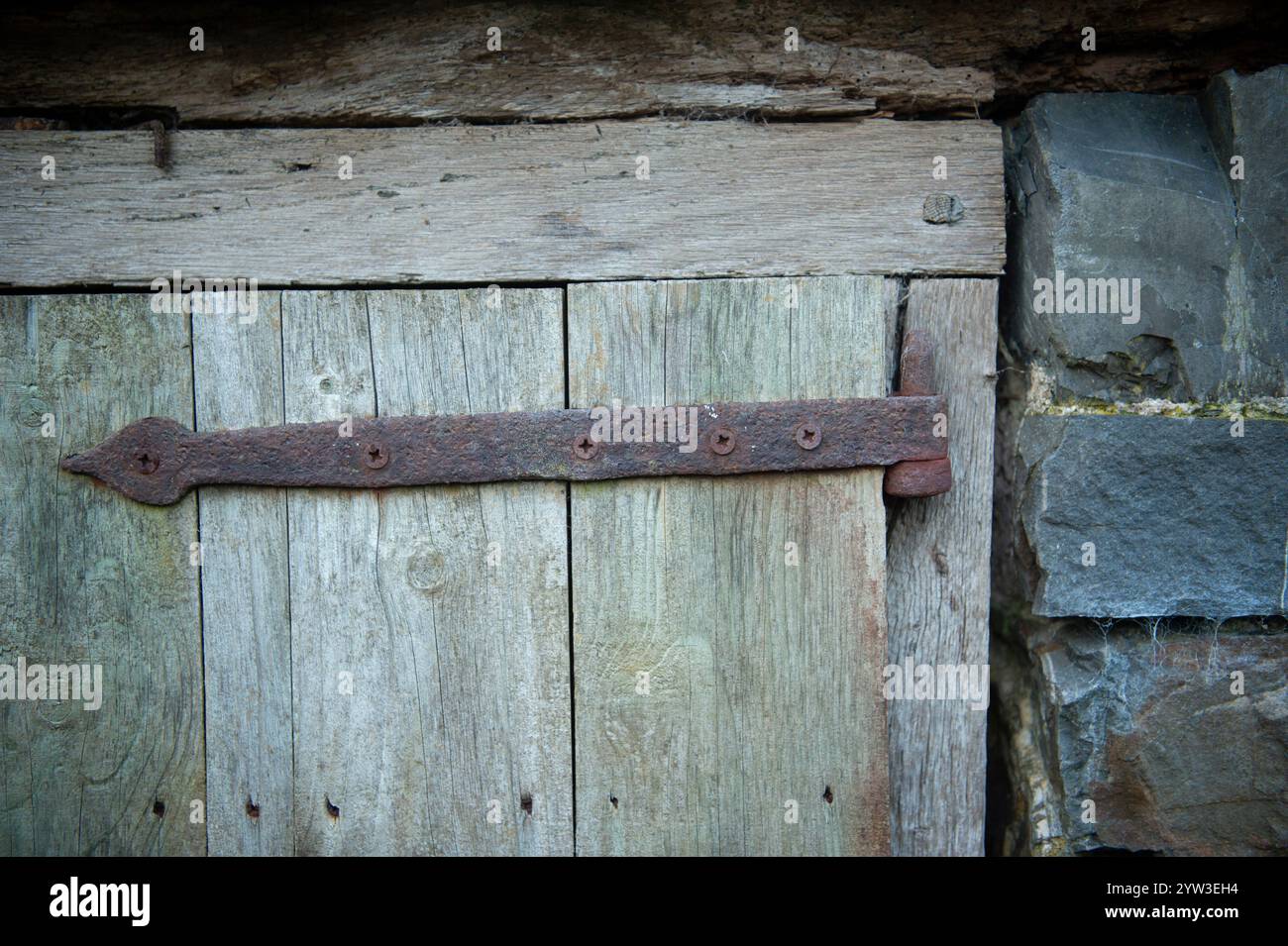 vintage rusty hinge on an old barn door Stock Photo