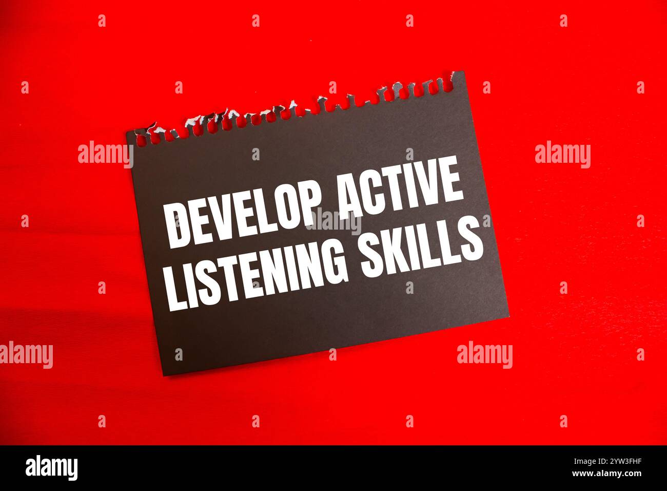 Develop active listening skills message written on black paper with red ...