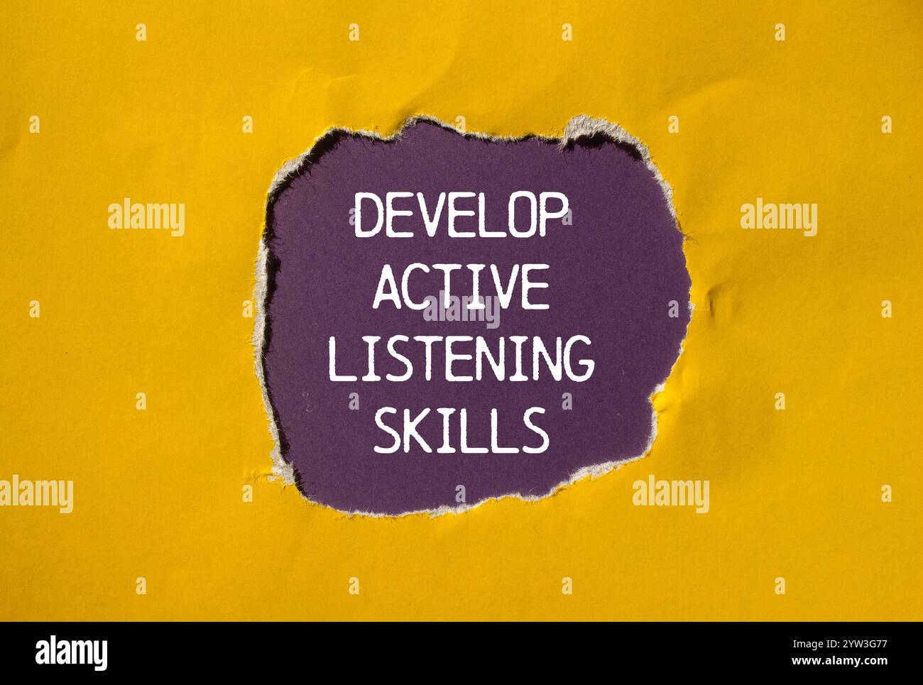 Develop active listening skills message written on ripped torn yellow ...