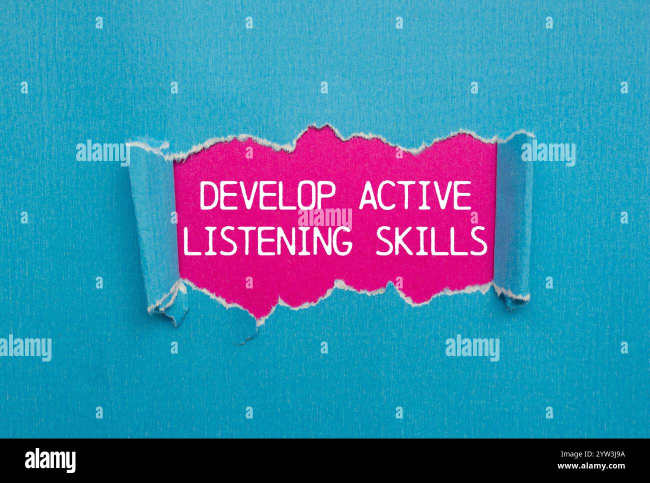 Develop active listening skills message written on ripped torn blue ...