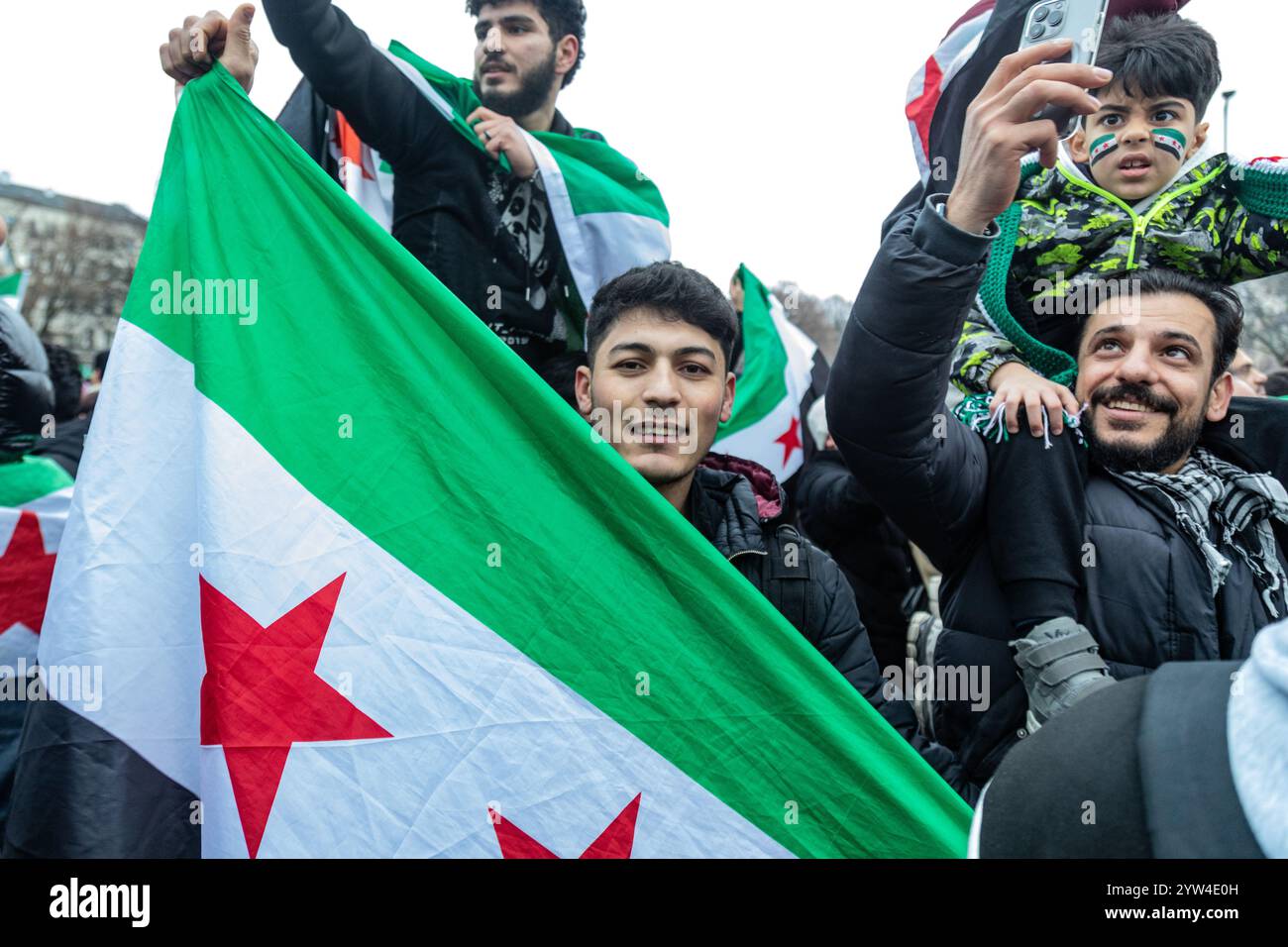 Berlin Germany 08th Dec 2024 A young man holds up a Free Syrian