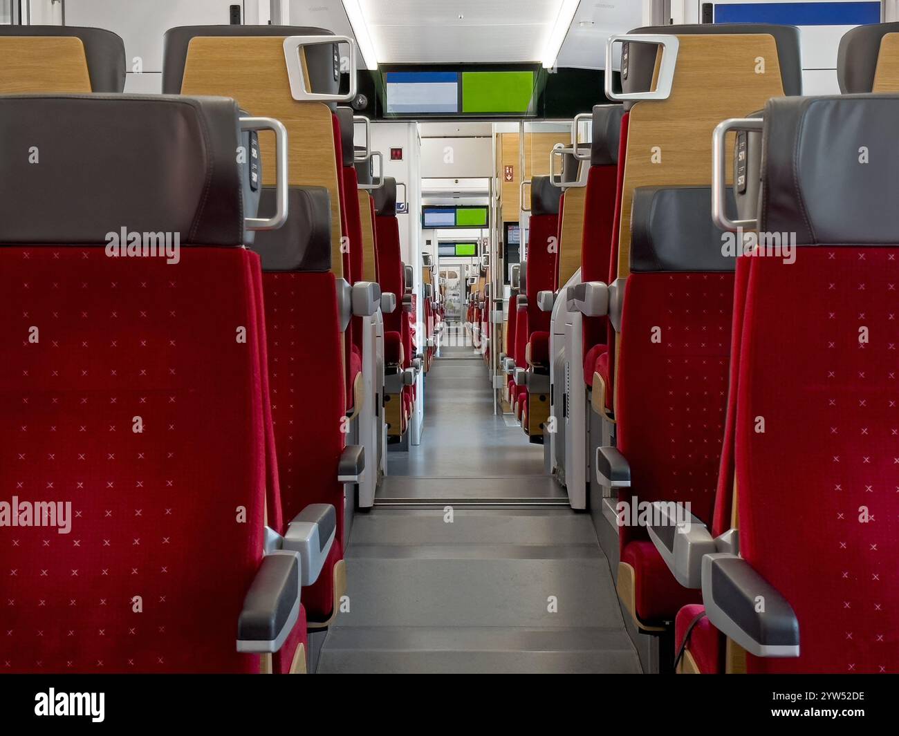 The inside of a modern passenger train is shown, with no riders currently onboard. - Smartphone Captured Stock Image