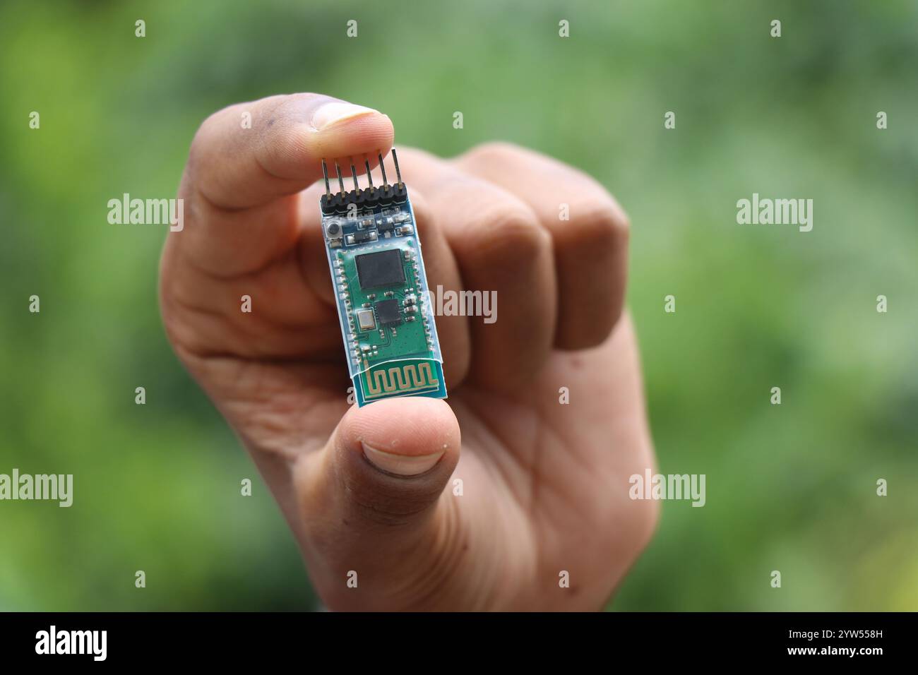 Bluetooth module used for wireless communication used in making robotics project held in the hand Stock Photo