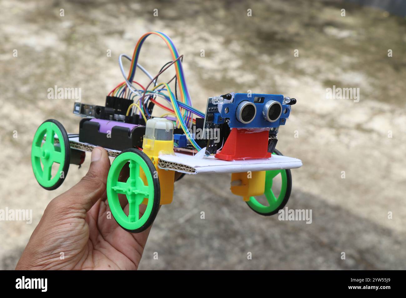 Robotic car built at home using programmable controller that follows human held in the hand that uses infrared and ultrasonic sensor Stock Photo