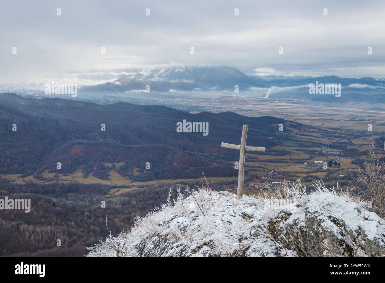 Wooden cross on the mountain covered with white snow in wintertime ...