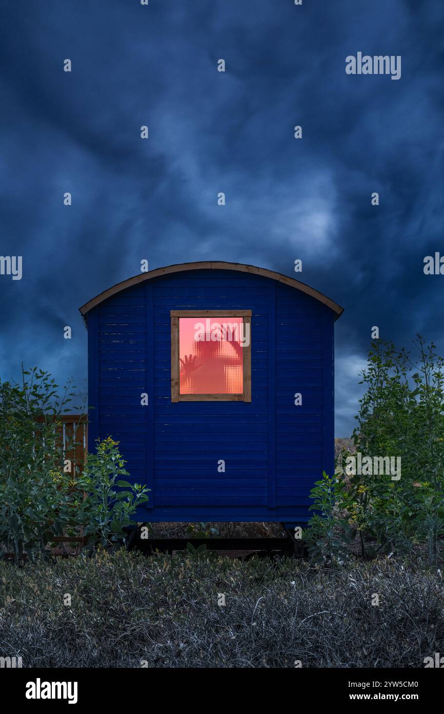 Woman with hands on window in wooden cabin. Abduction, prisoner, trapped, horror, hostage...book cover concept Stock Photo