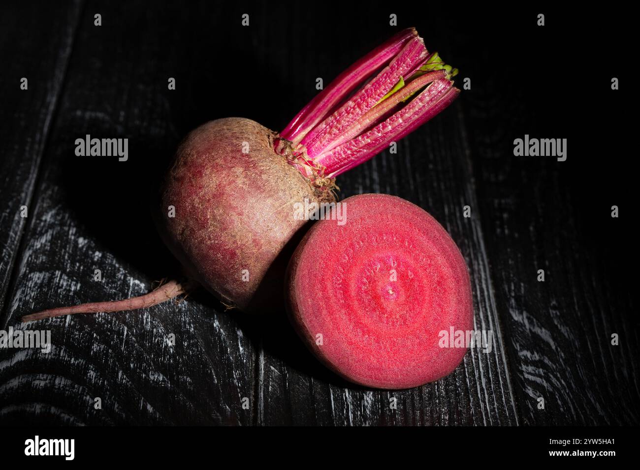 sliced beets on black wood background Stock Photo