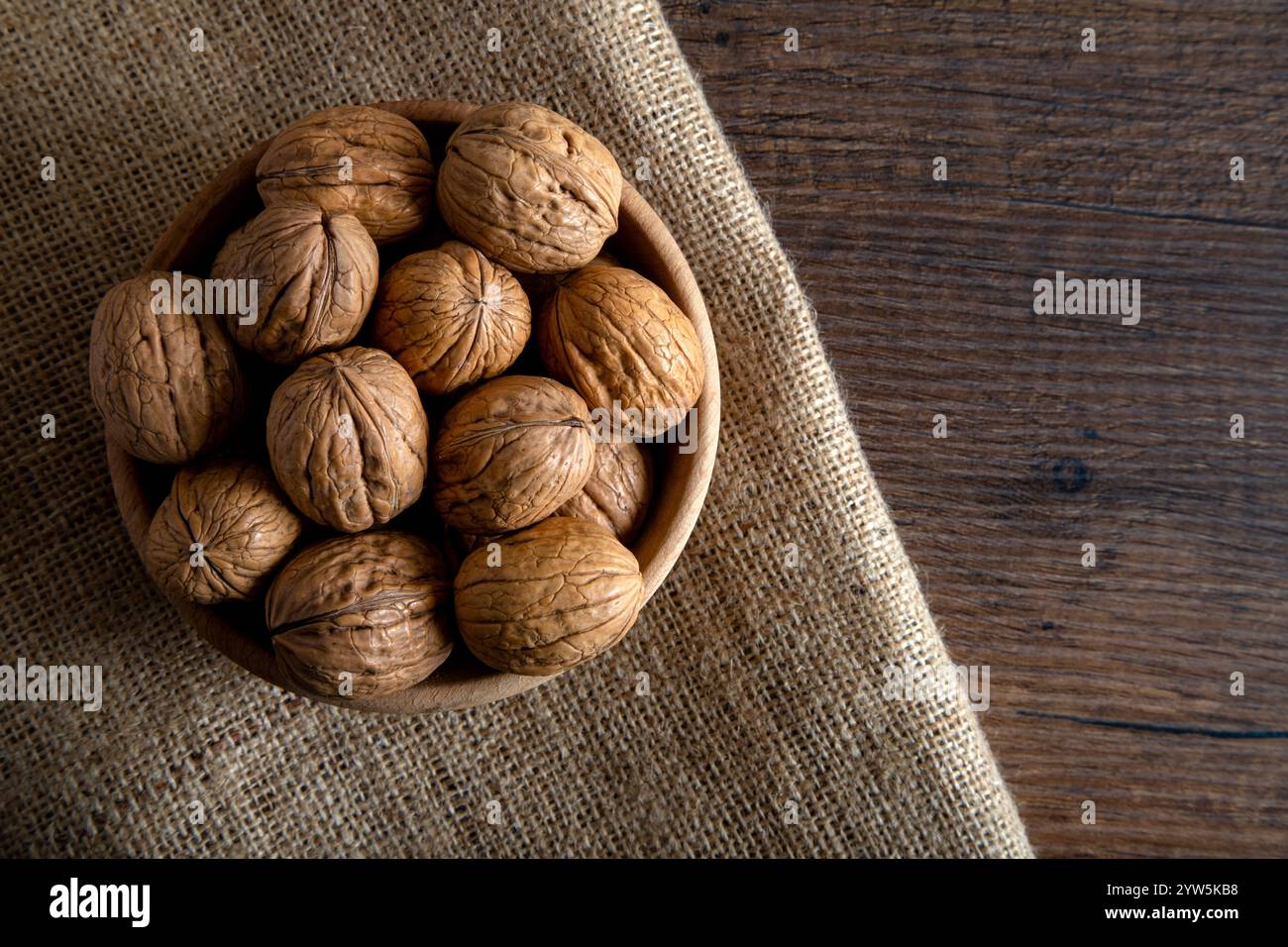 A bowl full of shelled walnuts on burlap sack,top view Stock Photo