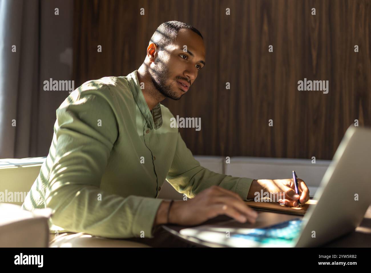 Confident man using laptop while working in office Stock Photo