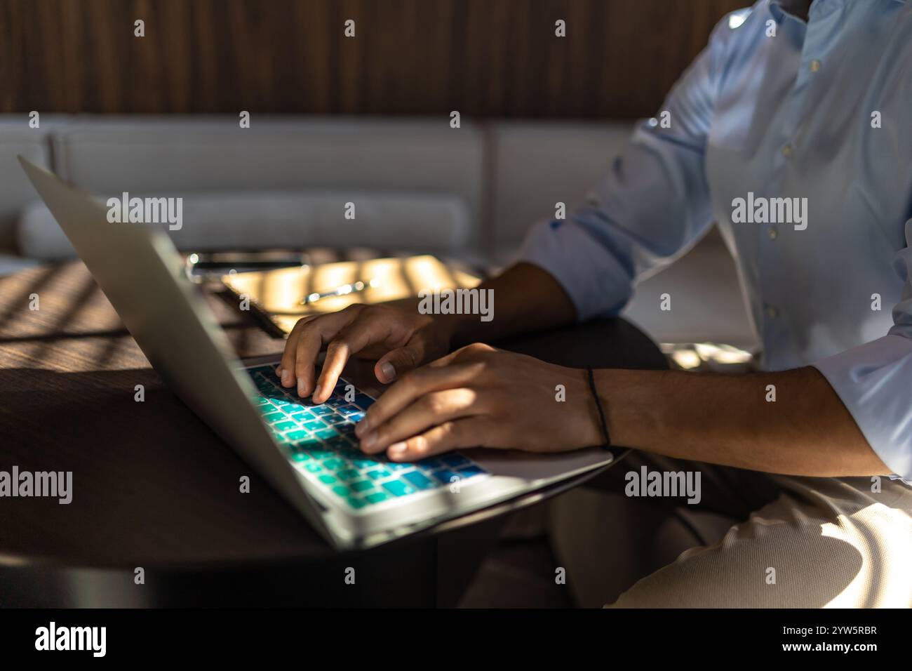 Unrecognizable man using laptop while working in office Stock Photo