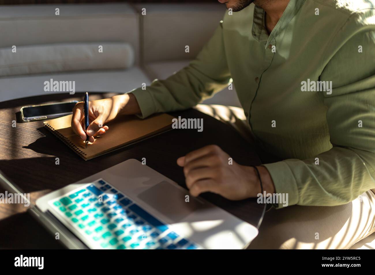 Unrecognizable man using laptop while working in office Stock Photo