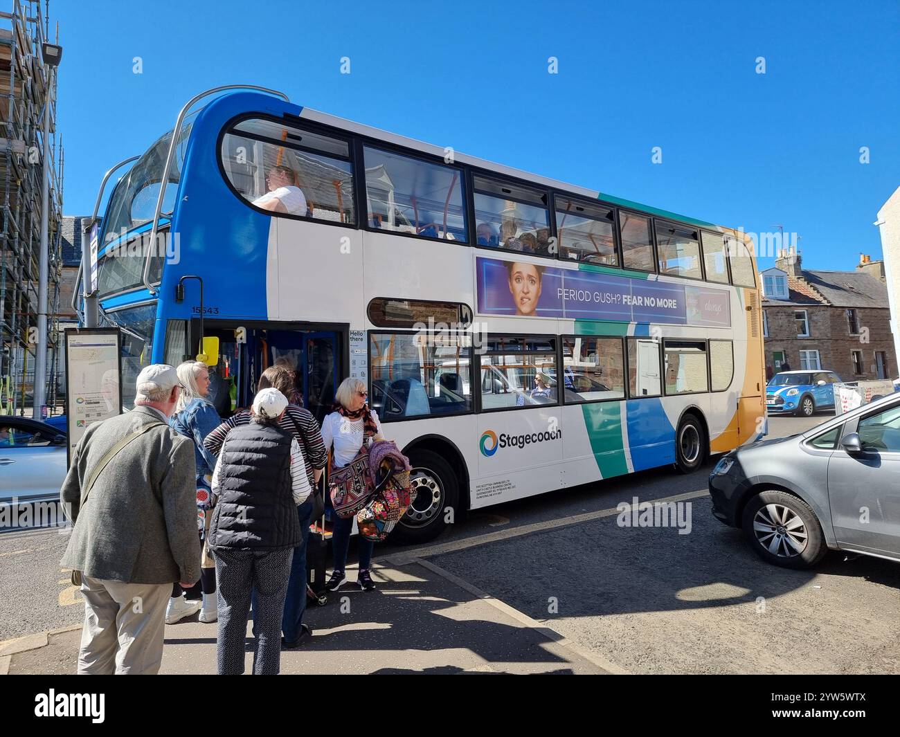 Elderly people entering a Stagecoach double-decker bus at a bus stop in Craig Fife Scotland UK on a sunny day - Smartphone Captured Stock Image