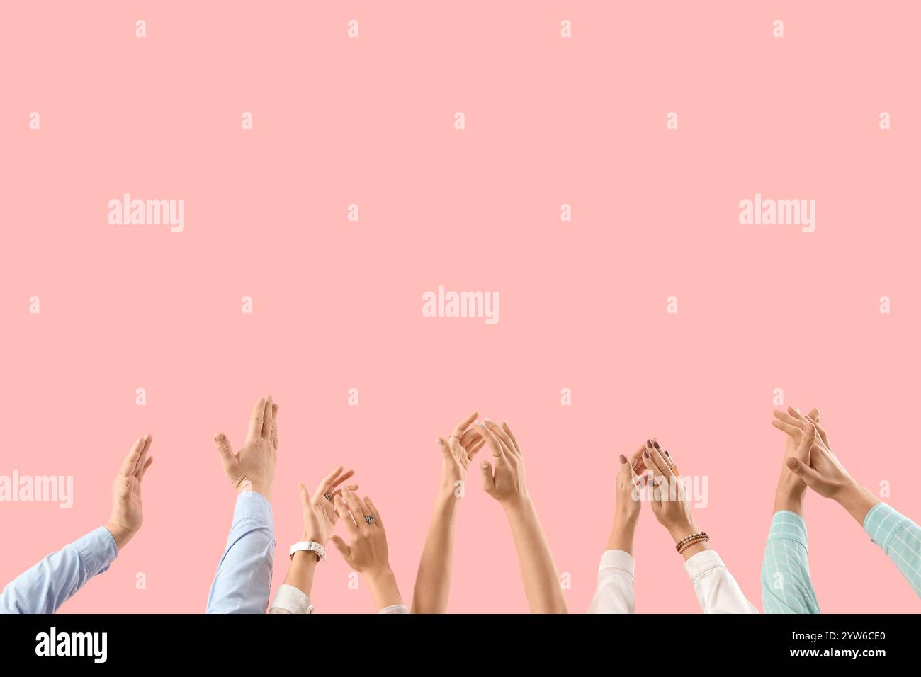 Many hands clapping on pink background Stock Photo