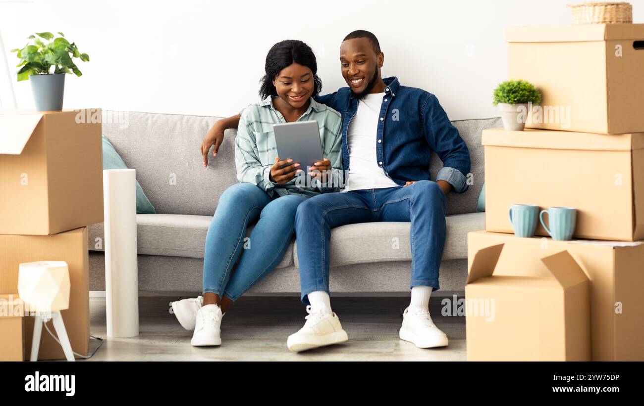 Happy Black Couple Using Digital Tablet Together After Moving To New ...