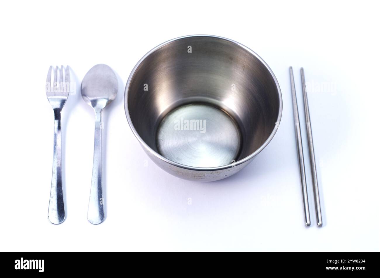 Stainless Steel Bowl Set With Utensils on White Background for Dining Stock Photo
