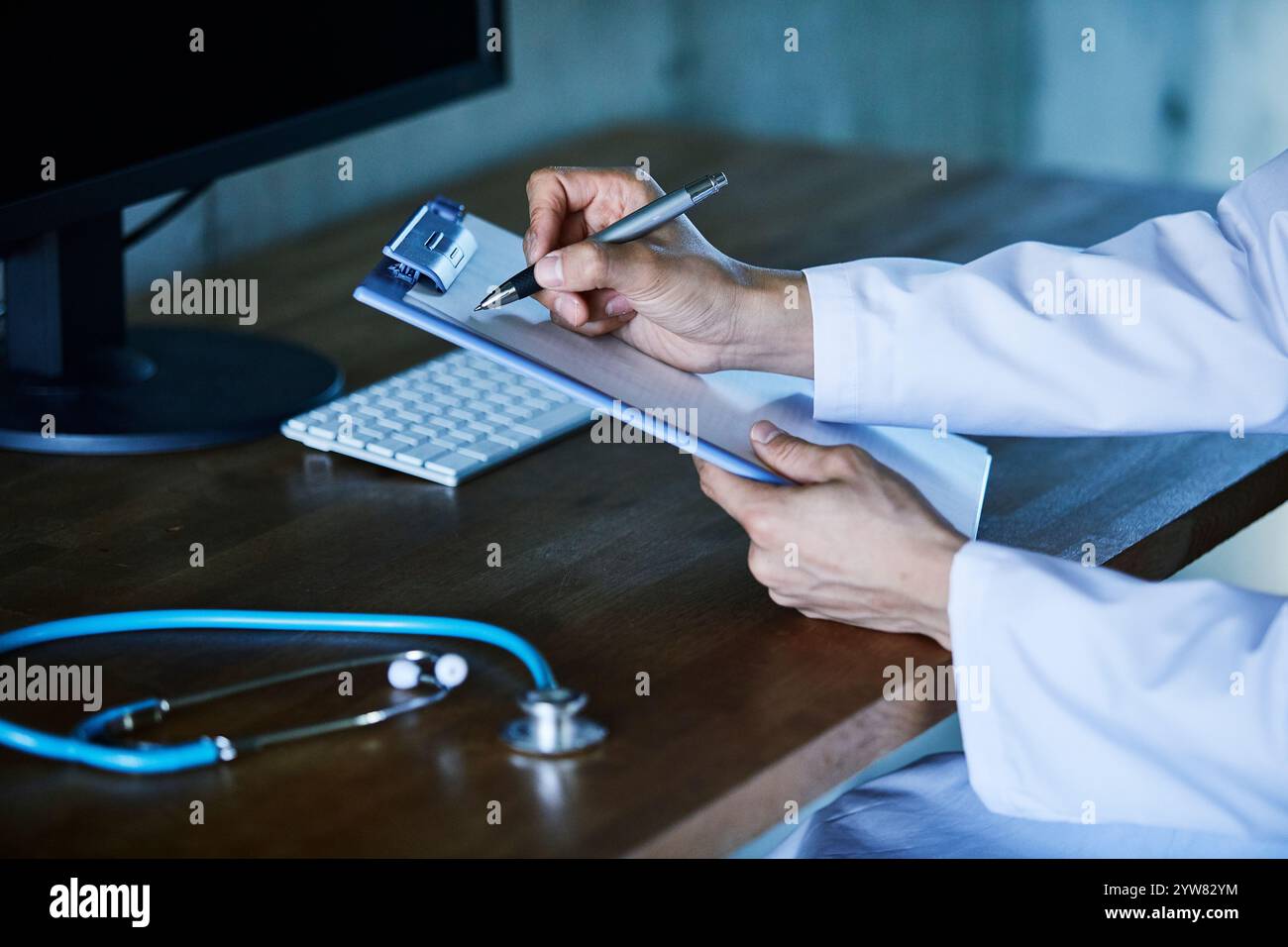 Computer, stethoscope, medical records and man's hand Stock Photo - Alamy