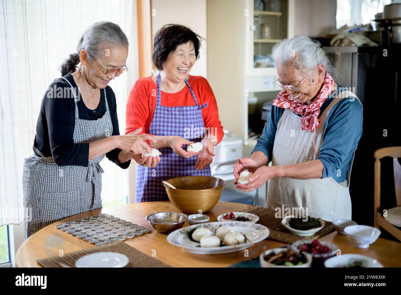Senior woman making rice balls with a smile Stock Photo - Alamy