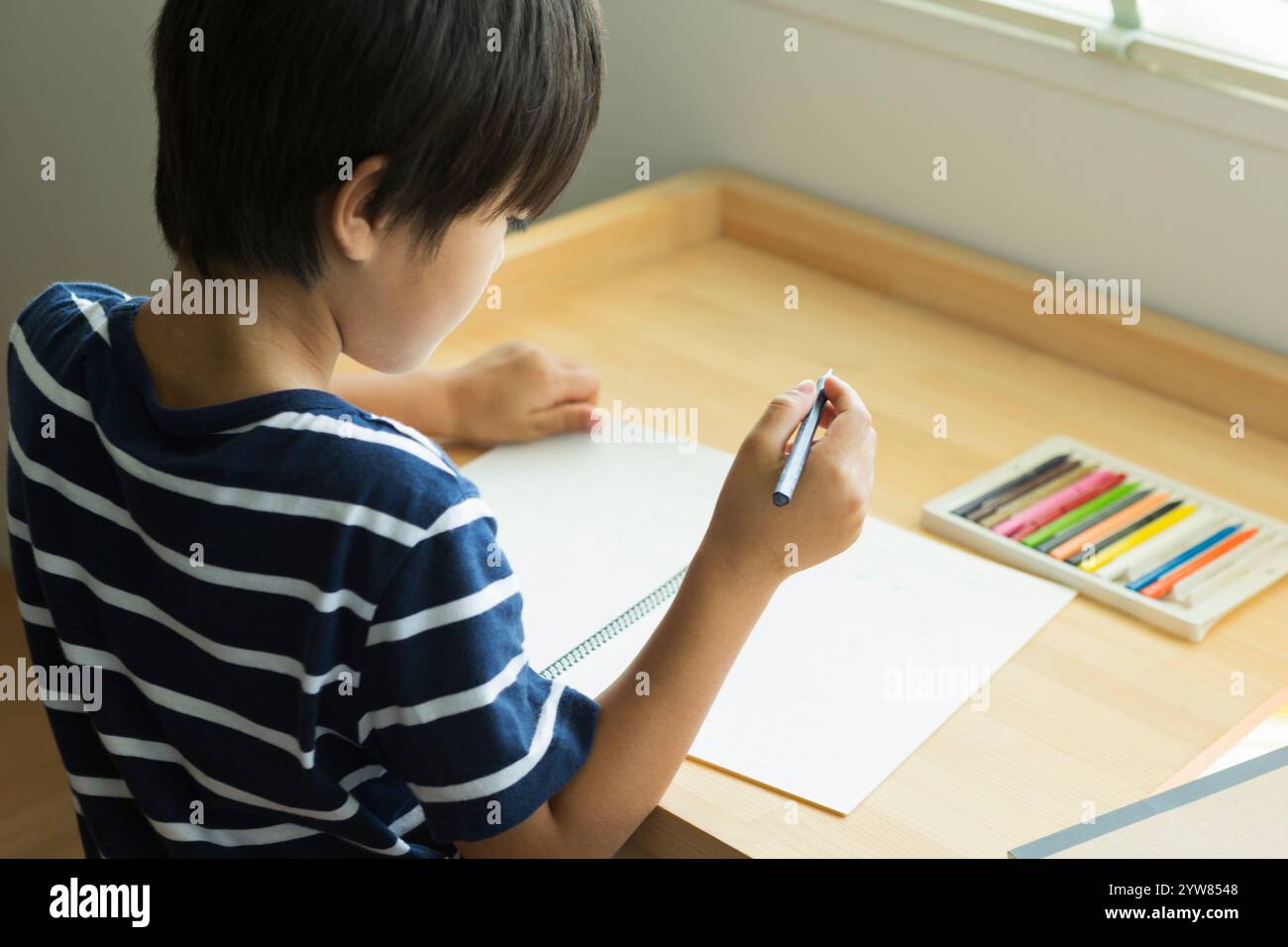Primary school boy drawing a picture Stock Photo - Alamy