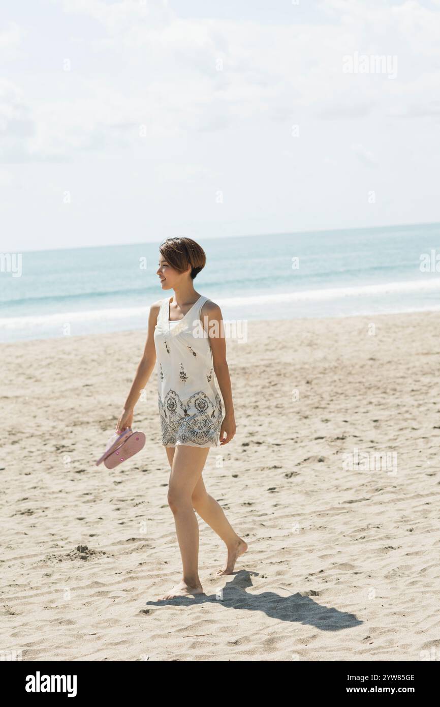 Woman alone on a beach hi-res stock photography and images - Alamy