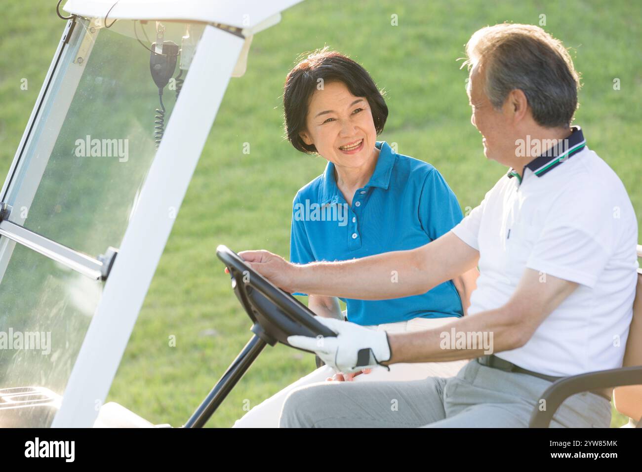 Senior couple in golf car Stock Photo