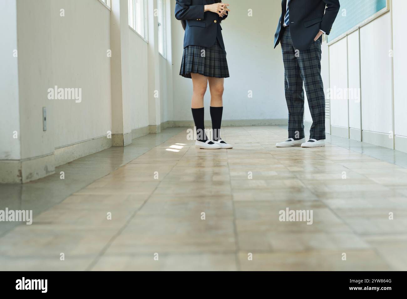 Male and female high school students talking in the corridor Stock ...