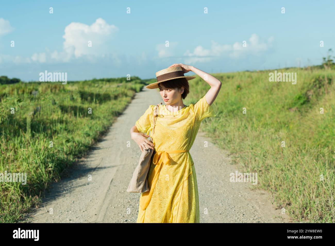 Woman walking on country road Stock Photo - Alamy