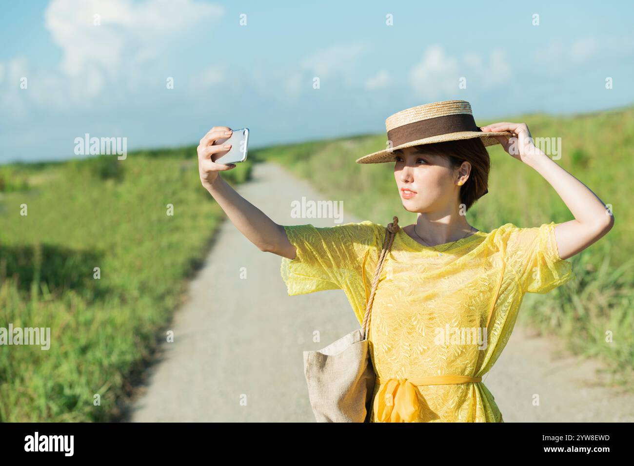 Woman walking on country road Stock Photo - Alamy