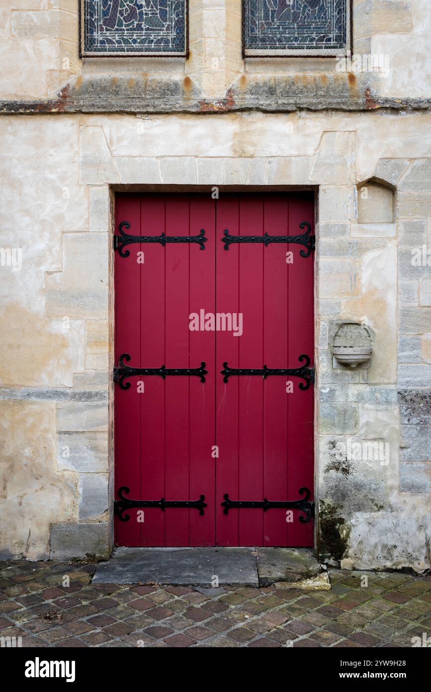 Red wooden door in an ancient stone wall Stock Photo - Alamy