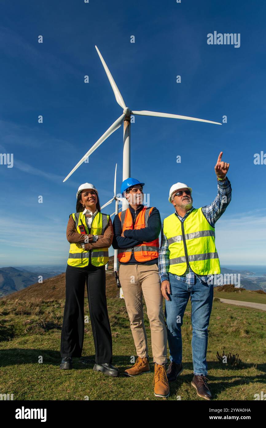 Three Multiethnic Engineers Wearing Safety Vests And Helmets Are