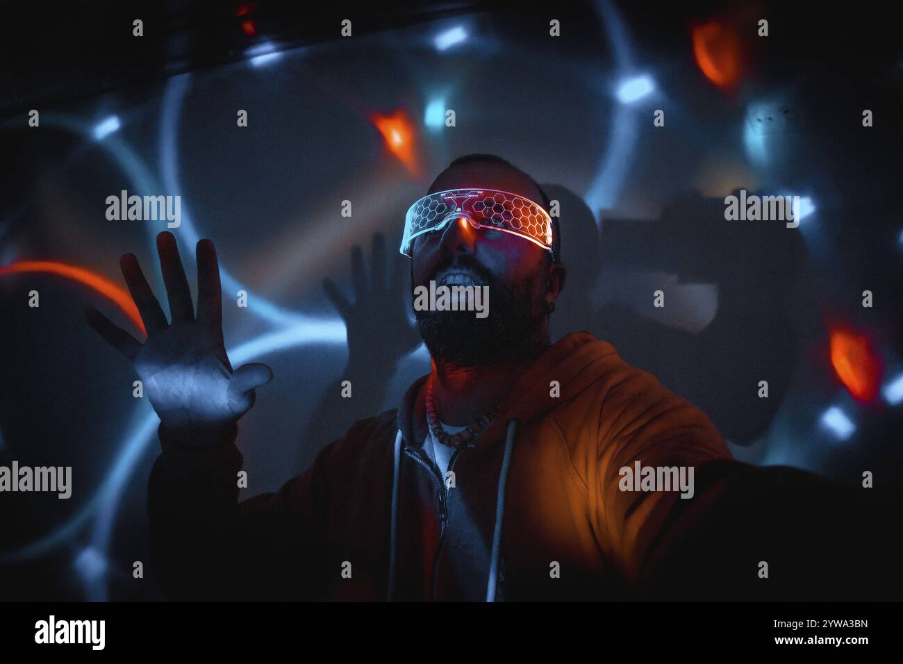 Bearded man wearing futuristic glasses interacting with virtual reality ...