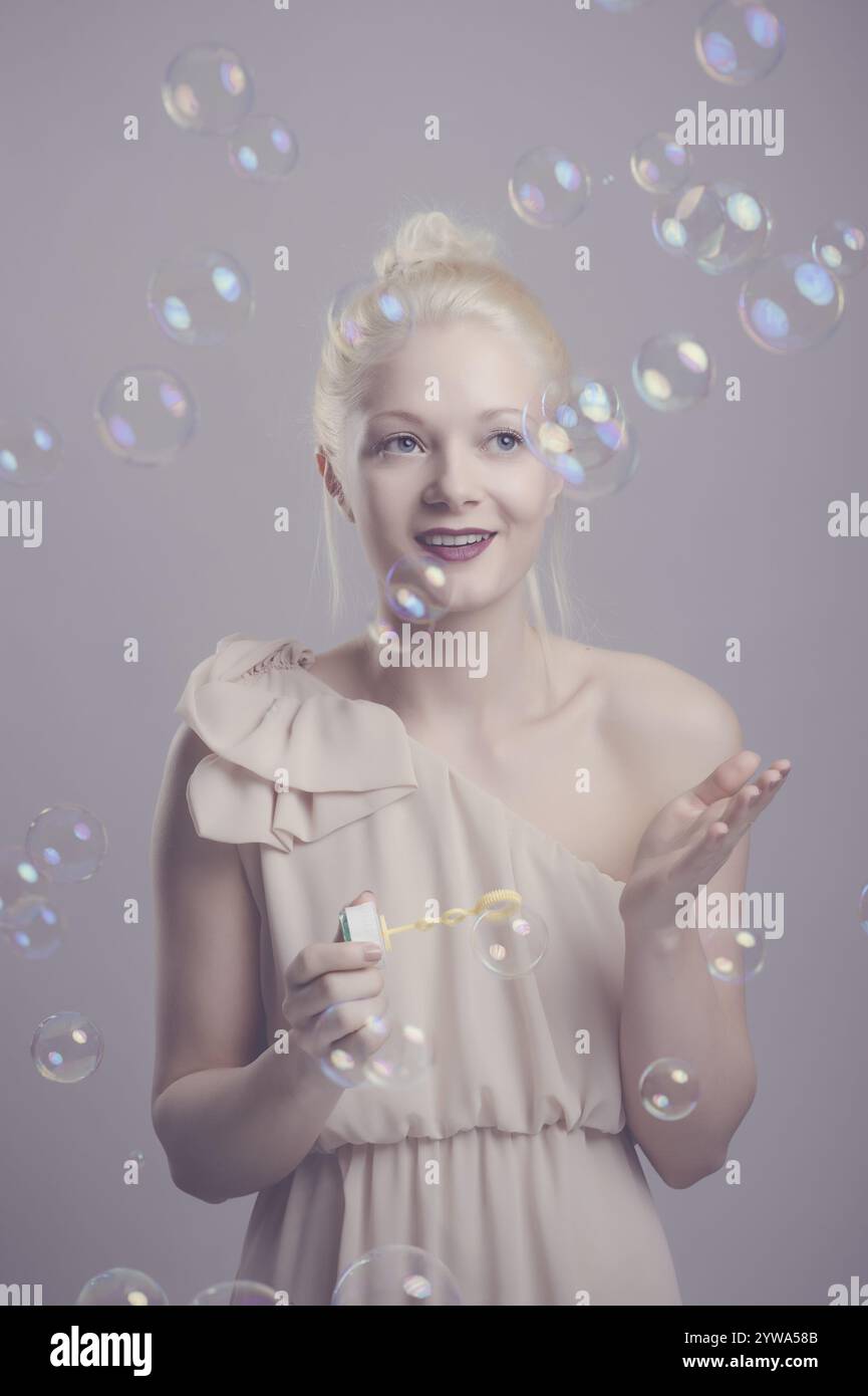 Young, blonde woman with soap bubbles Stock Photo