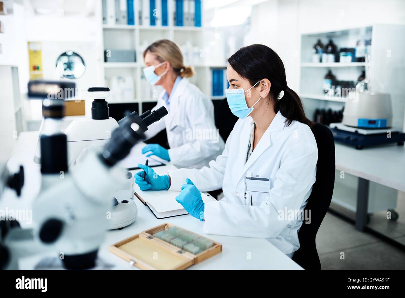 Notes, research and scientists in laboratory for experiment, project or ...