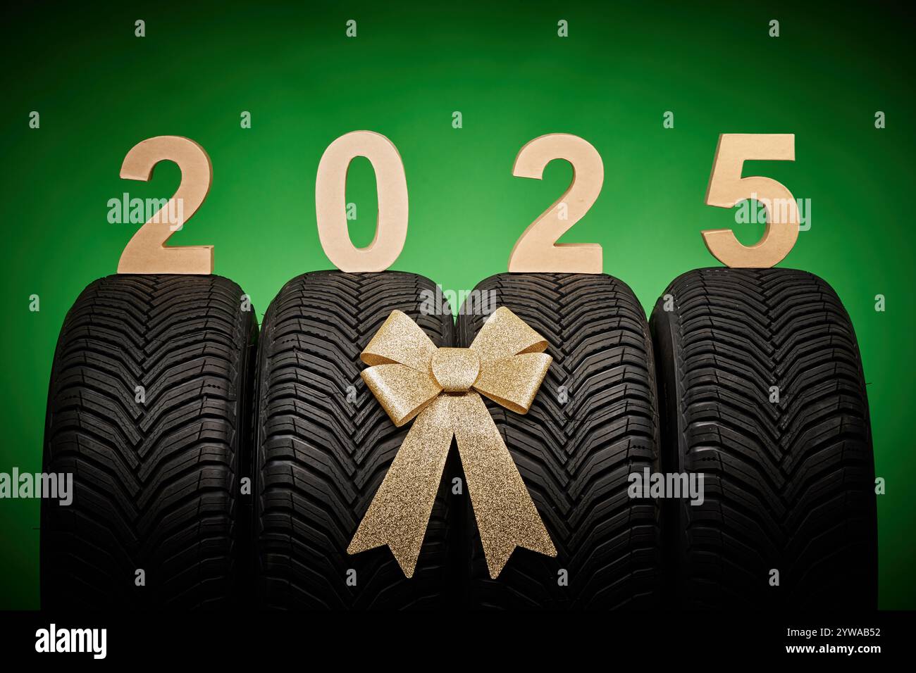 Car Tires New Tyres Winter Wheels Isolated On Green Background With Car Tires New Tyres Winter Wheels Isolated On Green Background With Bow Ribbon Present 2025 New Year Celebration 2YWAB52