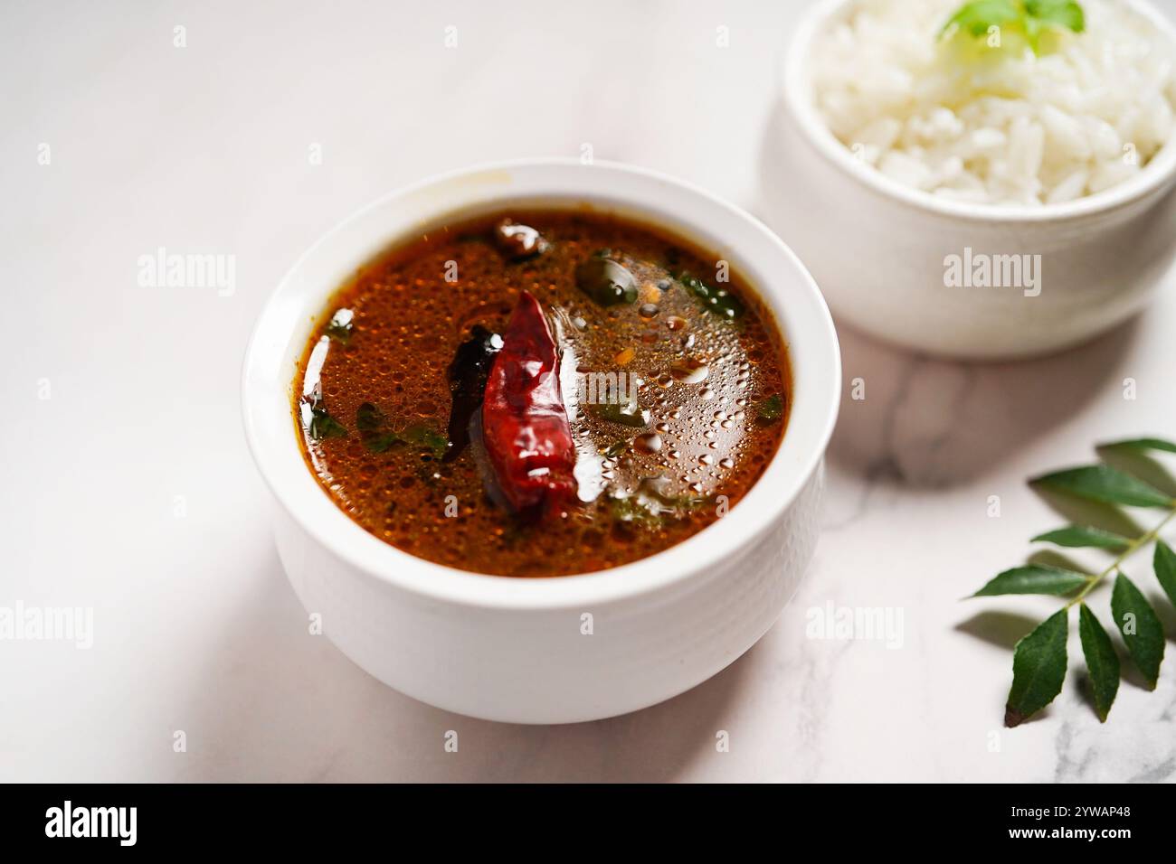 Tomato rasam served with rice, selective focus Stock Photo