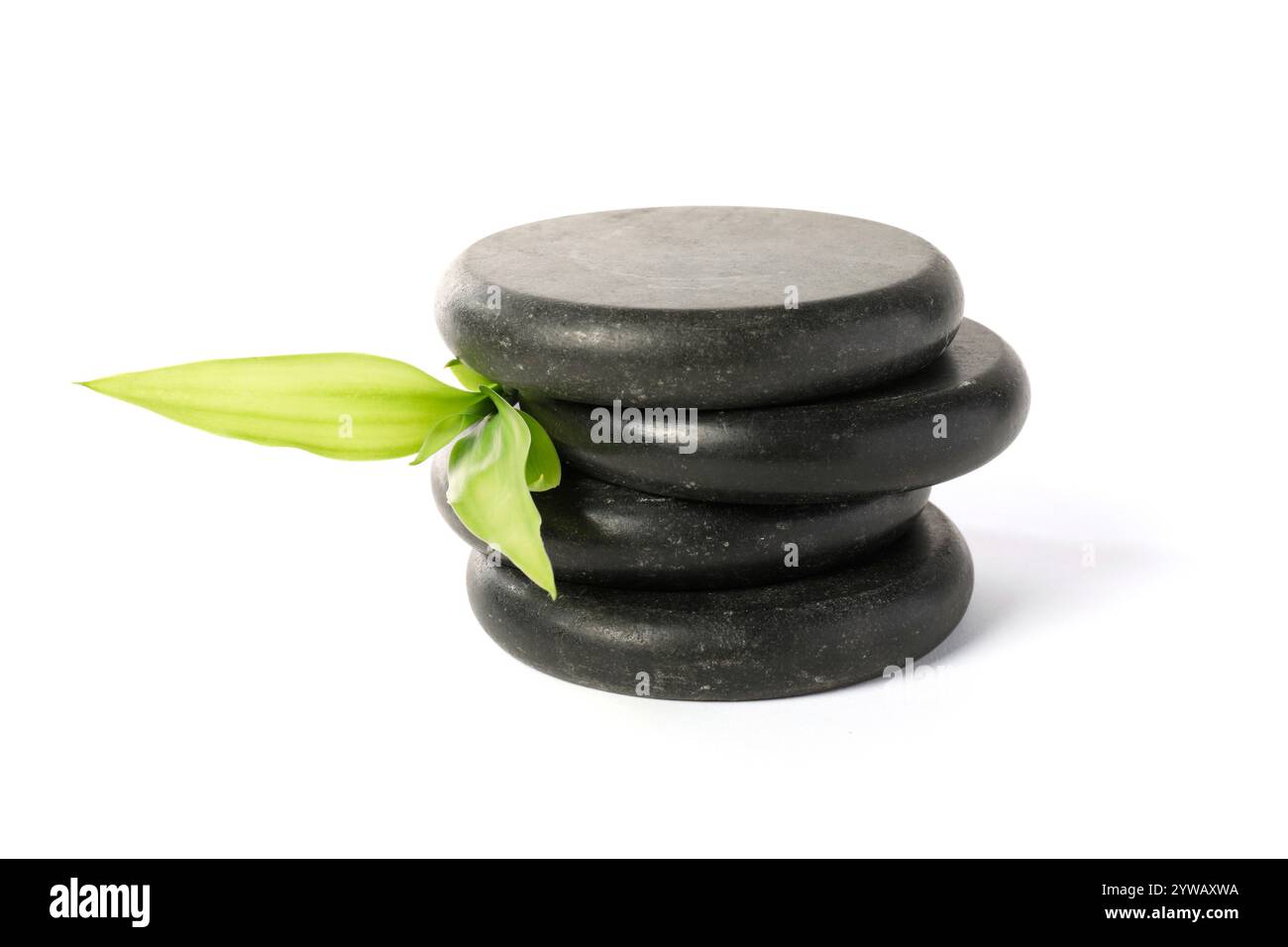 Spa stones and green leaves isolated on white Stock Photo - Alamy