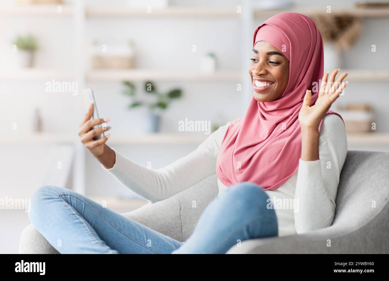 Black Muslim Lady In Hijab Making Video Call With Smartphone At Home ...