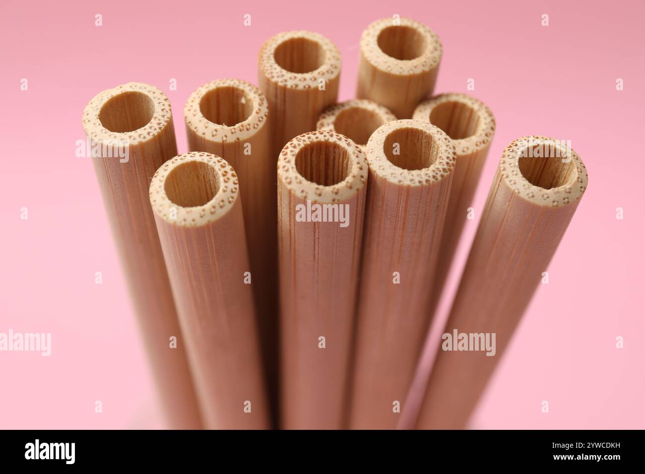 Bamboo drinking straws on pink background, closeup Stock Photo