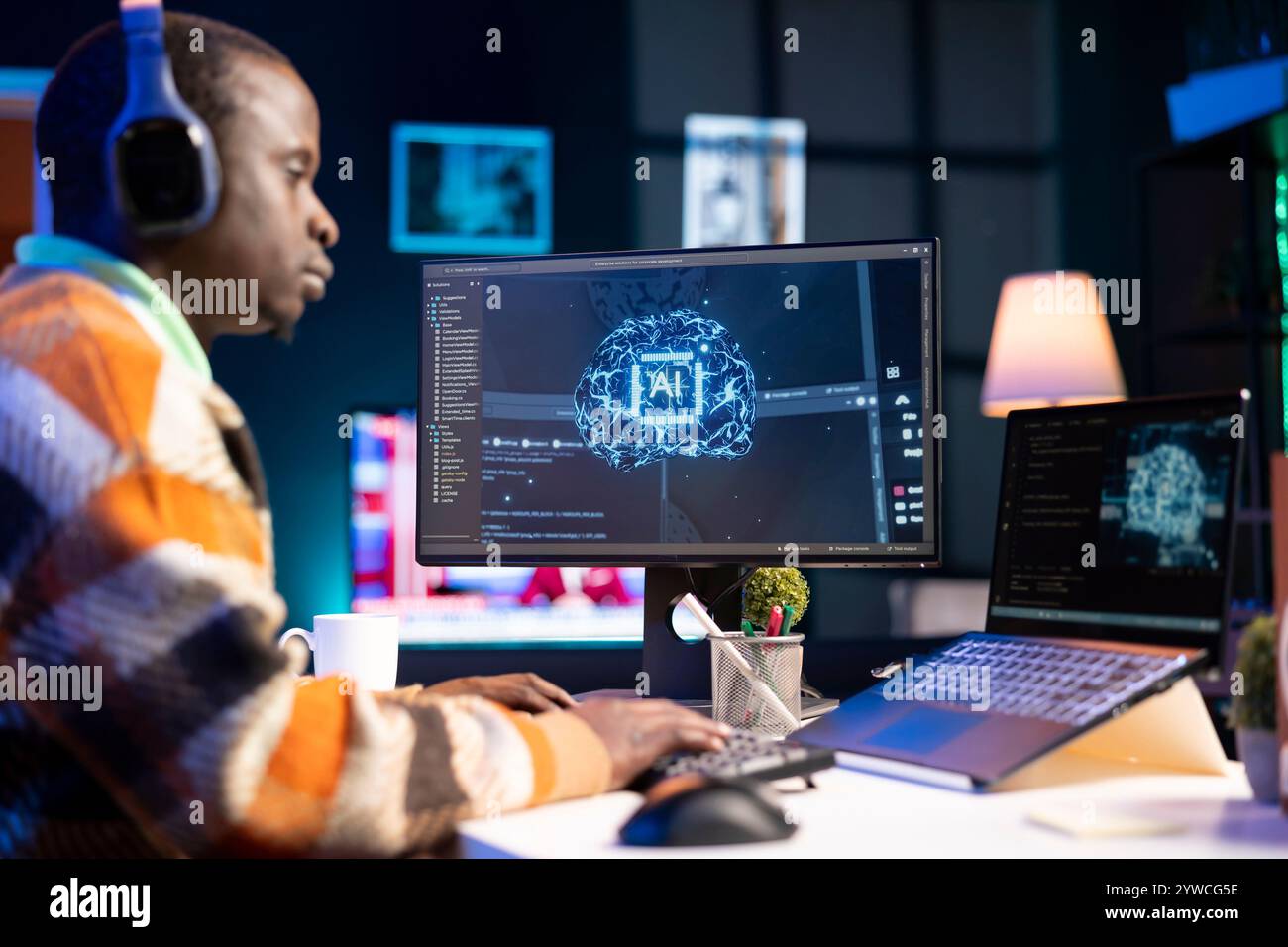 African american man working on computer to write code and programming in artificial intelligence and deep learning. Male IT engineer using pc to ensure cyber security, neural network. Stock Photo