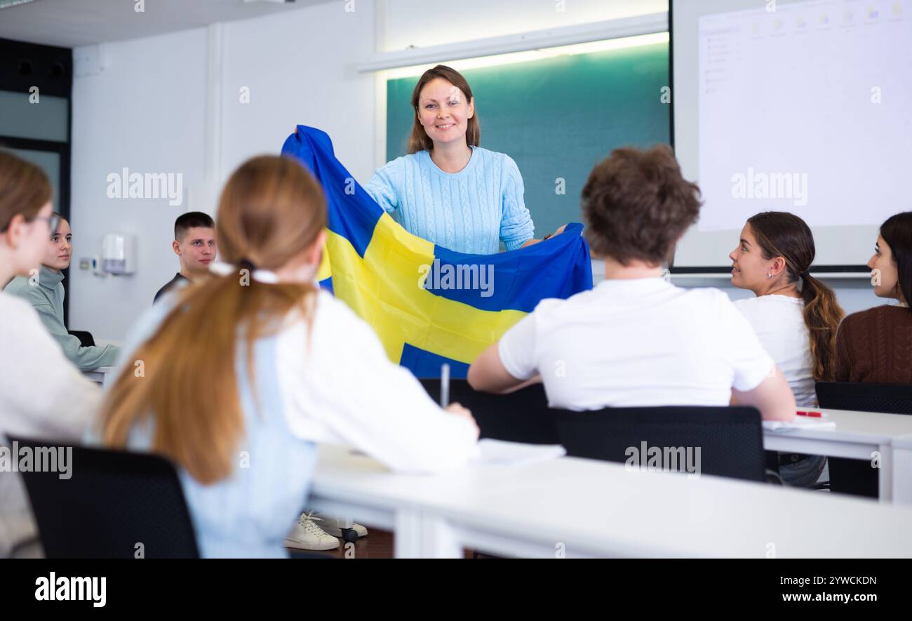 An Adult Teacher Shows The Flag Of Sweden To Students Stock Photo Alamy an-adult-teacher-shows-the-flag-of-sweden-to-students-stock-photo-alamy