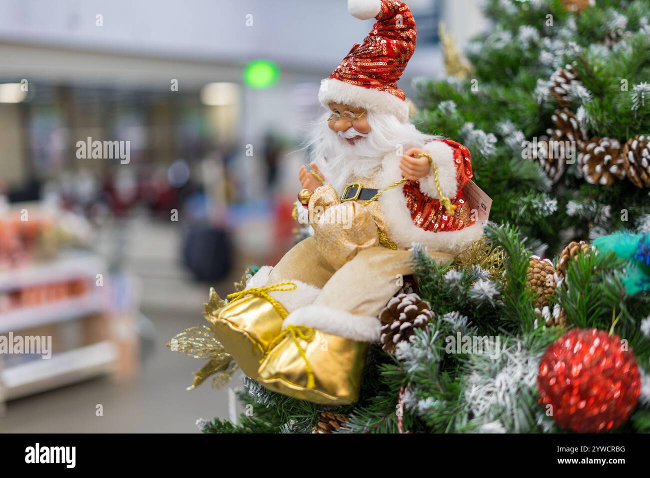 Christmas Santa Claus figure under the tree Stock Photo - Alamy